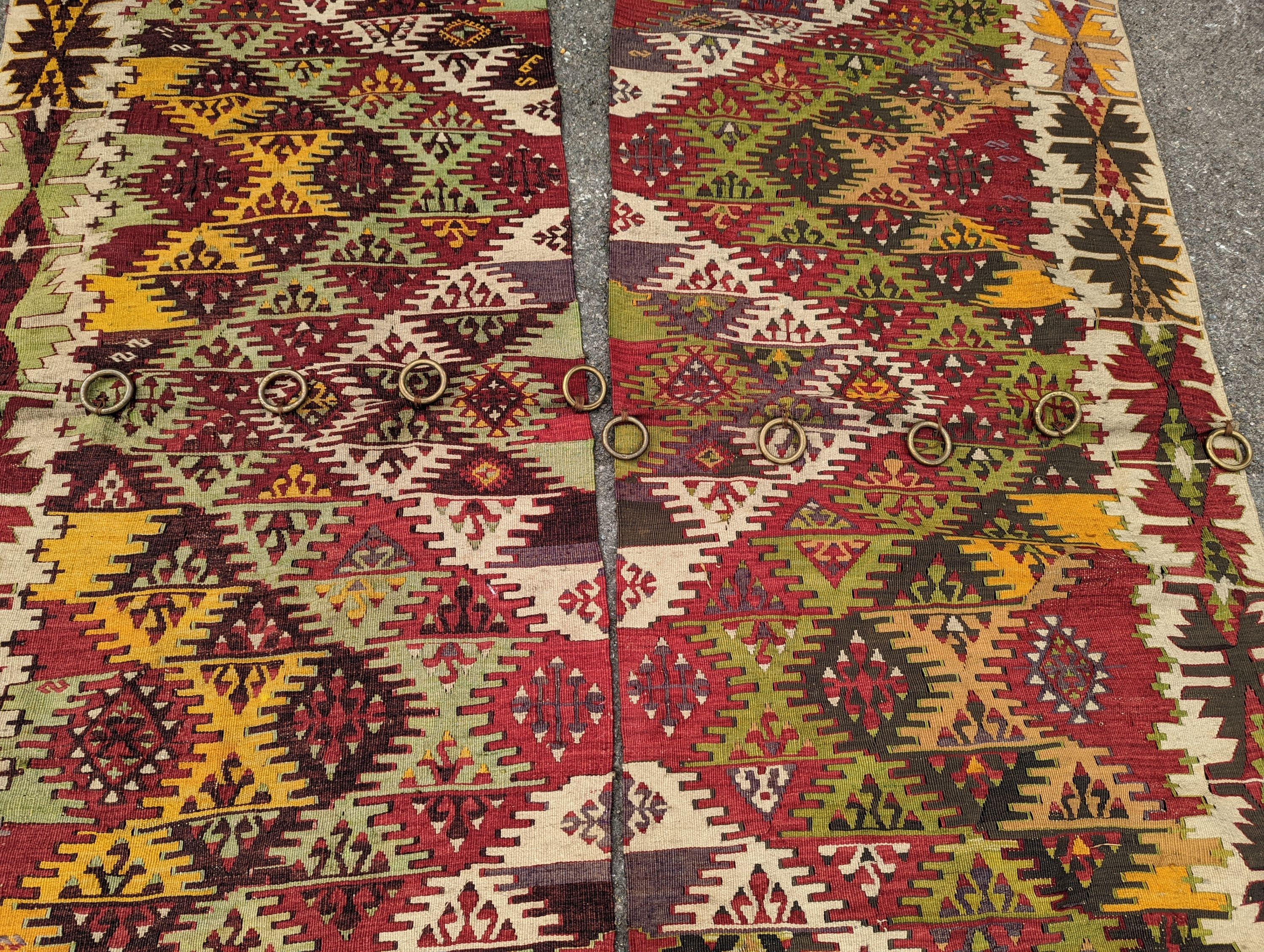 A Kelim polychrome flatweave carpet, cut centrally to create a pair of runners, each 410 x 85cm